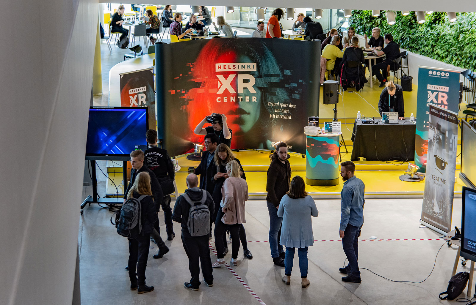 Helsinki XR Center's roadshow stand at Metropolia University of Applied Sciences' Myllypuro campus with a lot of interested people around the stand.