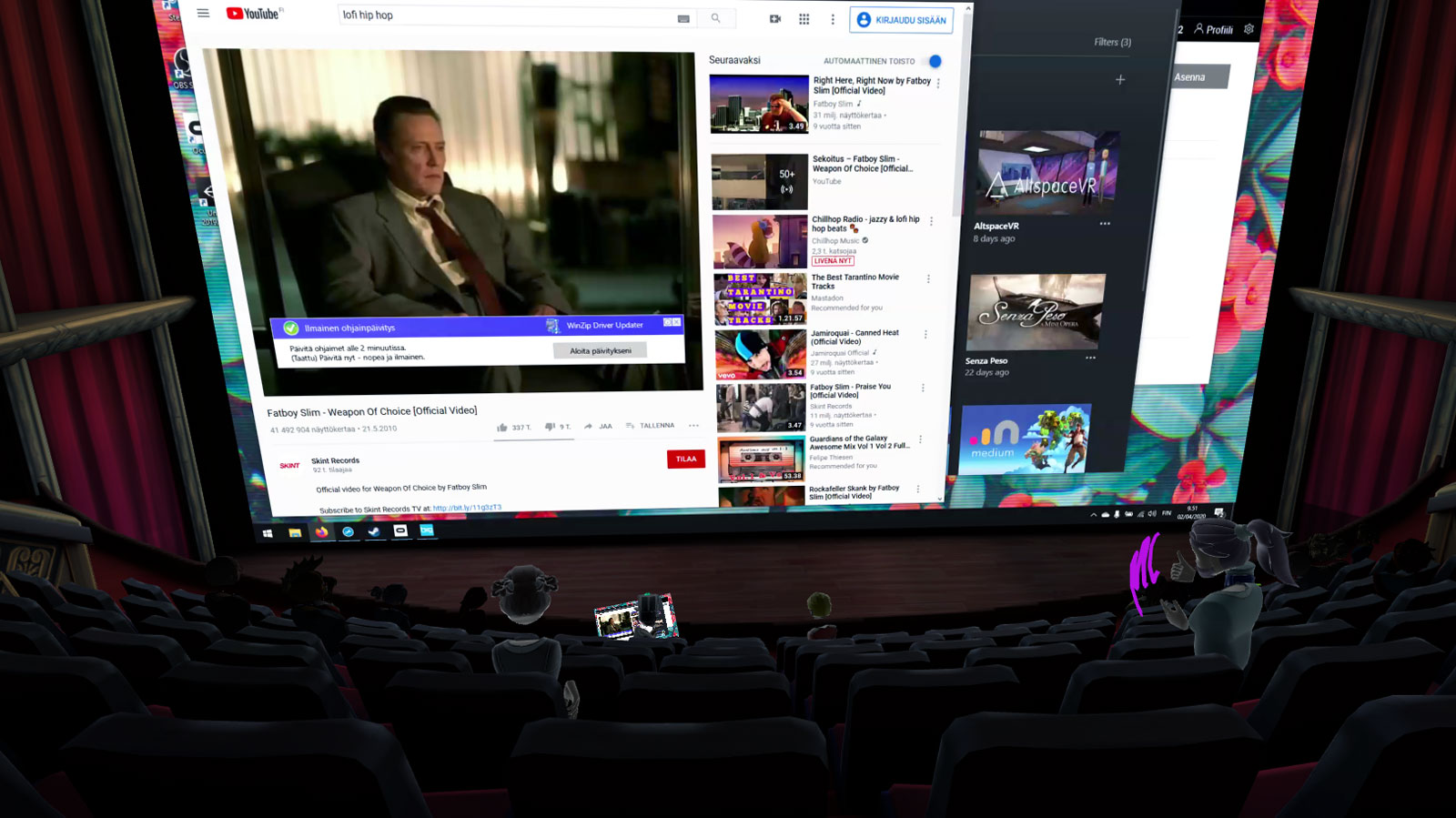 A screenshot of Bigscreen VR cinema. The theatre space is huge with only a few viewers. A screen is being shared to the big screen.