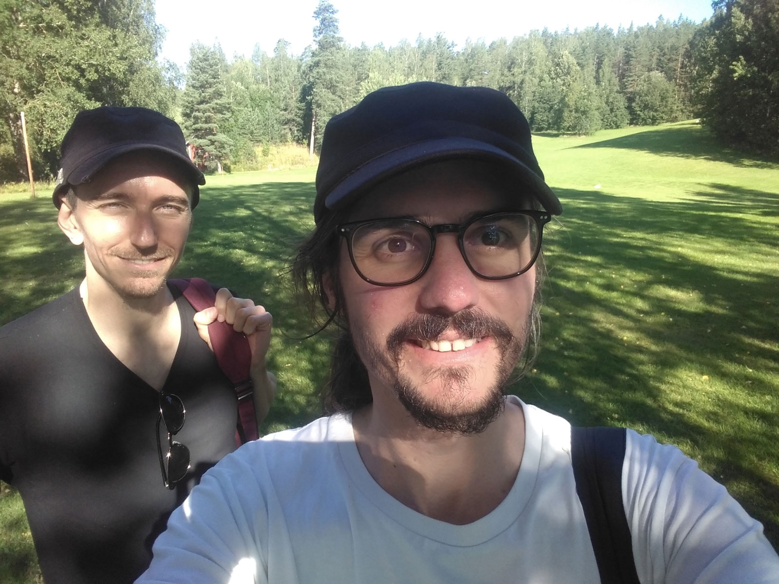 A selfie of Unfold Stories' Riccardo (on the left) and Lucio (on the right). Both are smiling widely on a sunny day.