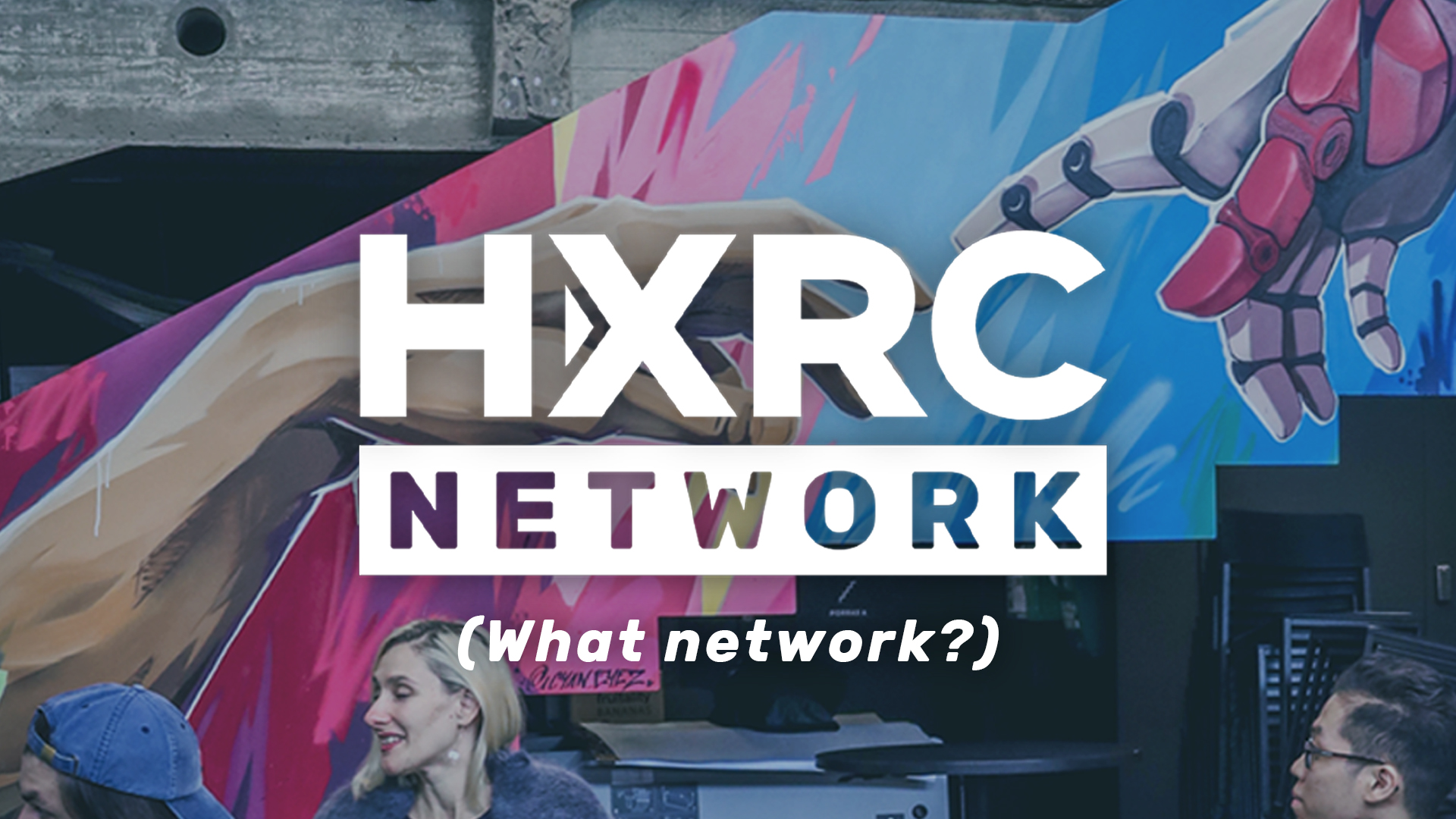 HXRC Network logo wih the text "(What network?)" on top of a picture of a colourful graffiti by Mike Leggat (aka Cyan Eyez). The graffiti is an imitation of the index fingers of two separate beings almost touching, from the famous painting "The Creation of Adam" by Michelangelo, but in this graffiti the other hand is a human hand, and the other hand is a robot hand.
